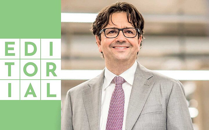 Dark haired man next to a green box with the text editorial