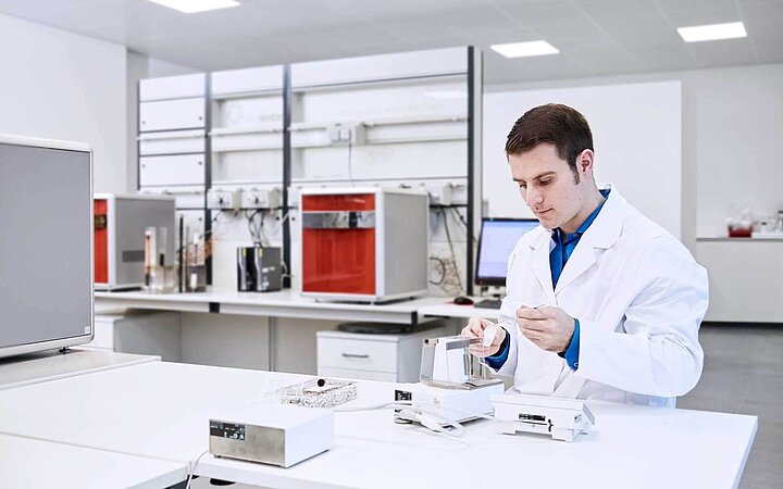 Laboratory technician weighing samples