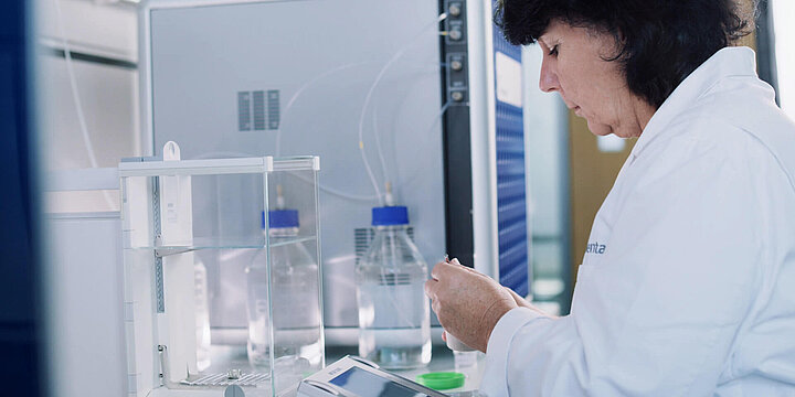 Woman weighing samples in a laboratory