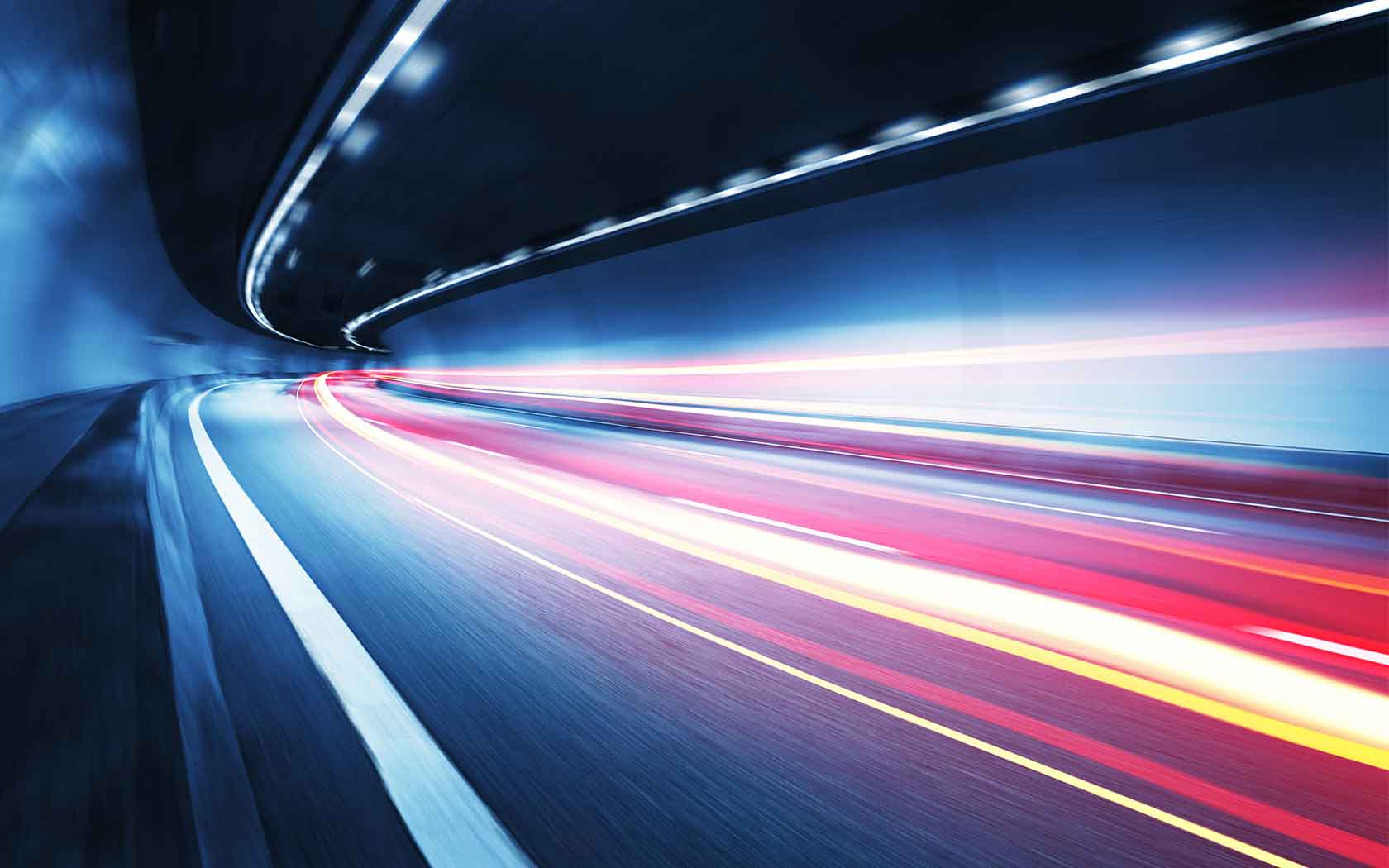 A highway with blurry, fast moving vehicles