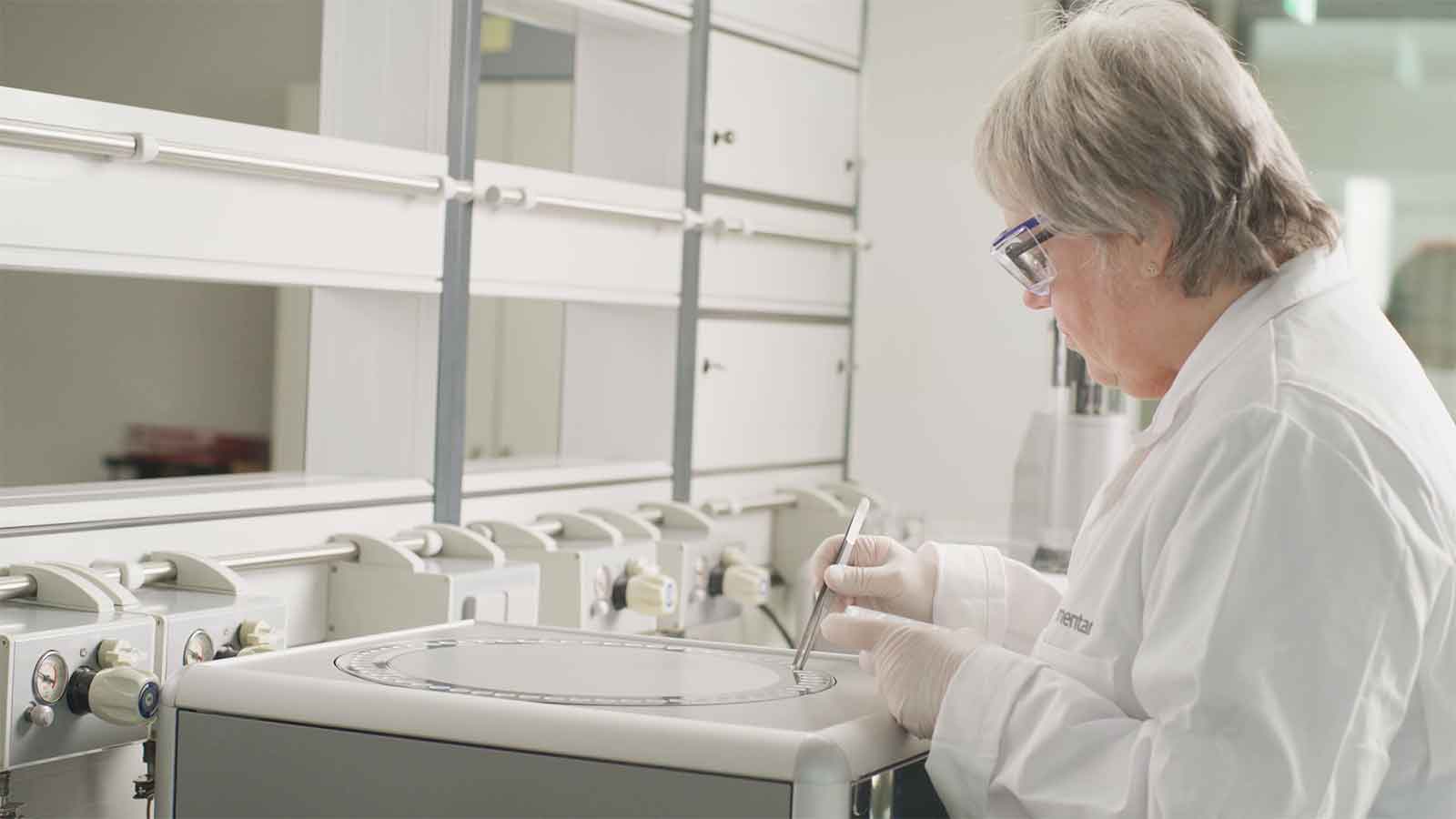 Female lab employee is placing samples on an elemental analyzer